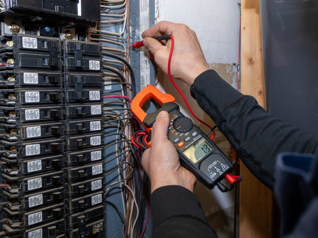 Electrician testing home circuit breaker.