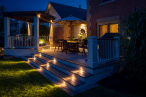 A beautifully lit deck featuring a gazebo, illuminated under the night sky, creating a serene outdoor atmosphere